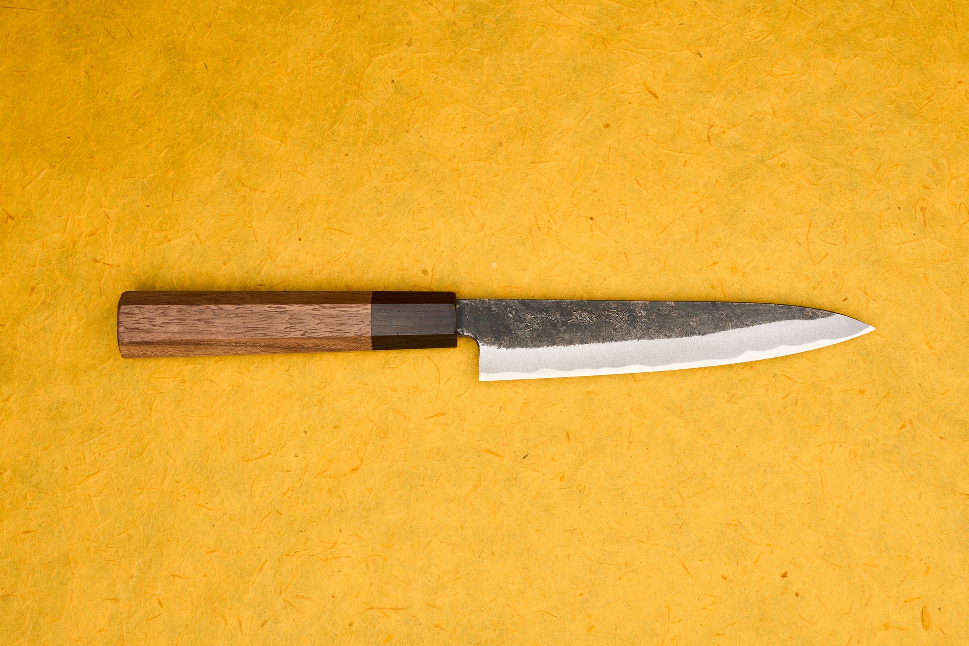 Touroku Sakai Yoshikazu Shirogami Kurouchi Petty 150mm knife, featuring a slender, razor-sharp blade with a temper line and an octagonal wooden handle, ideal for precise cutting tasks.